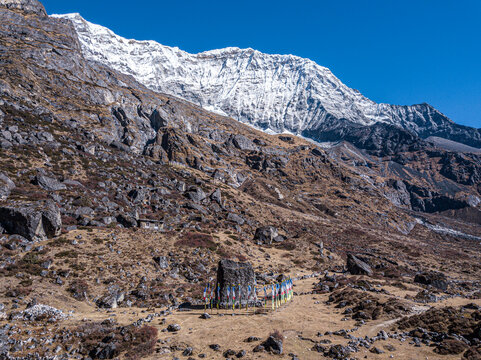 Aerial view of Rolwaling valley with prayer flags and snow-capped mountains, Gauri Sankar, Nepal.