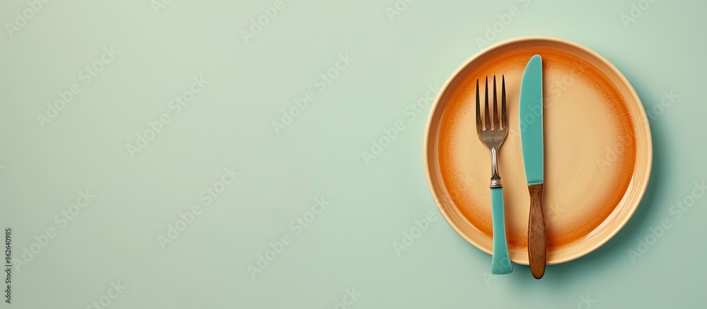 Aufkleber Top-down view of ceramic tableware including a plate with a fork on a plain background with space for text or other images. Copy space image. Place for adding text and design