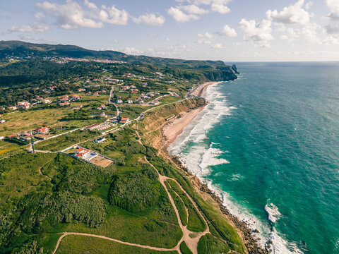 Aerial view of Praia das Macas, a touristic beach along southern Portuguese coastline facing the North Atlantic Ocean, Colares, Portugal.