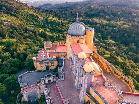 Aerial view of Pena Palace castle on mountain top in Sintra, view of the colourful interiors, SIntra, Lisbon, Portugal.