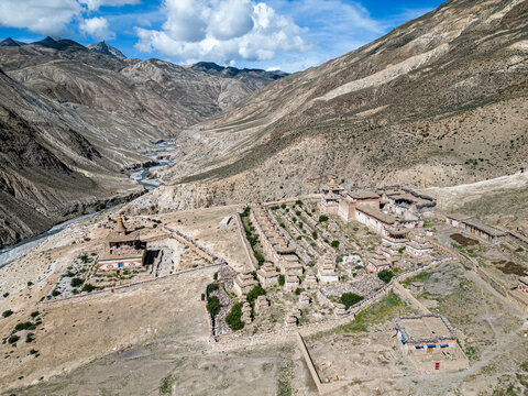 Aerial view of Yanjer Gompa Monastery, Tora Khola River, and Mountains in serene Dolpa, Nepal.