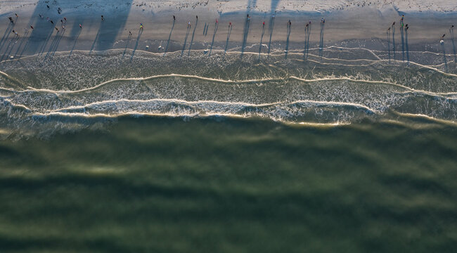 Aerial view of serene beach with people walking, St. Pete Beach, Florida, United States.