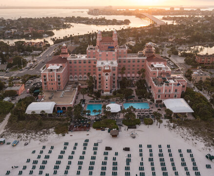 Aerial view of luxury hotel and beach with ocean view, pool, chairs, and bridge, St. Pete Beach, Florida, United States.