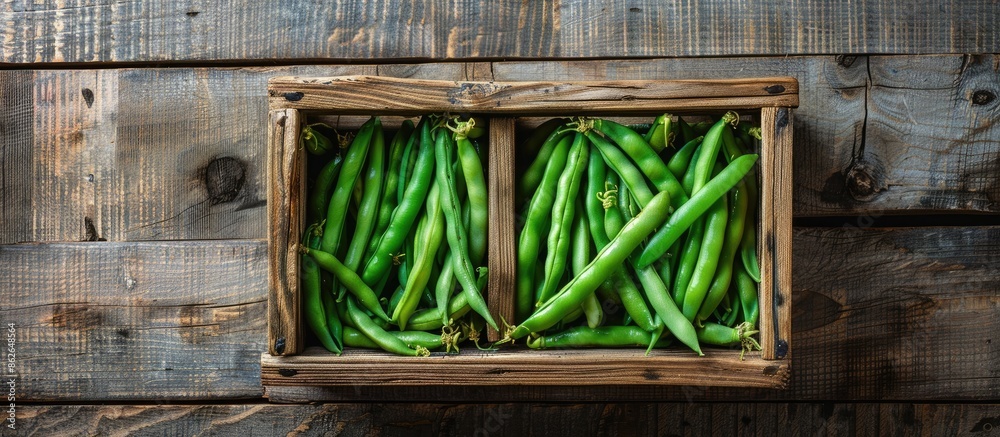 Poster fresh organic green common beans or kidney beans in a wooden box for cooking, set against a wooden b