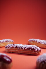 beautiful delicious eclair with coconut cream filling and raspberry jelly. confectionery, sweets....