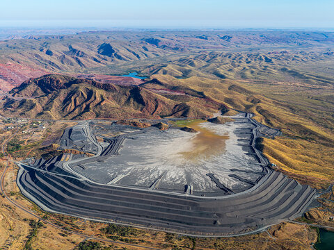 Aerial view of open pit mine, mountains, and valley in rugged terrain, Purnululu, Western Australia, Australia.