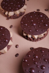 delicious dessert with chocolate cream, hazelnut praline and coffee. crispy base and chocolate decor. tasty pastry tart. modern dessert. layers. european confectionery
