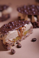 delicious dessert with chocolate cream, hazelnut praline and coffee. crispy base and chocolate decor. tasty pastry tart. modern dessert. layers. european confectionery
