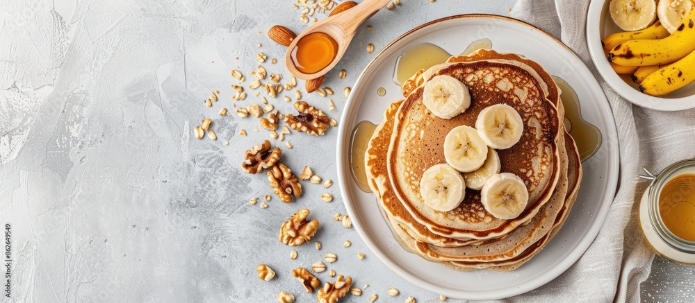Poster Walnut and banana pancakes displayed on a table with copy space image.