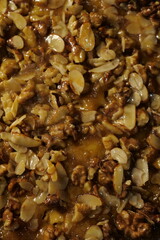 delicious tart with hazelnuts, almonds and caramel. pie with nuts. sweet pastry. close-up of a beautiful shiny cake