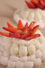 pavlova cake with soft white cream and strawberries. meringue cake. small pastry close up
