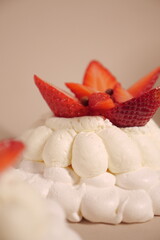pavlova cake with soft white cream and strawberries. meringue cake. small pastry close up