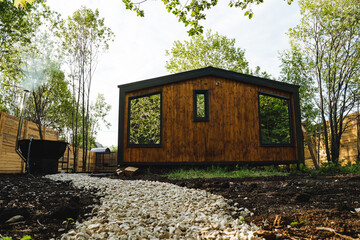 Nestled in the forest, a charming wooden cottage effortlessly merges into the natural surroundings,...