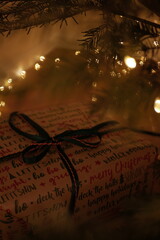 christmas and new year holidays. magical atmosphere. packaging and ribbons for gifts. beautiful boxes and things are packed in wrapping paper under the Christmas tree. christmas lights
