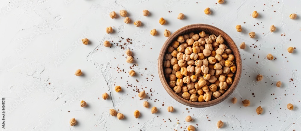 Poster Flat lay image of dried chickpeas on a white backdrop with copy space. Ideal for vegans seeking high-protein, high-carb healthy food. Top-down view.
