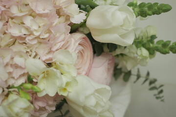 girly, cute, tender, beautiful bouquet. green, white and pink flowers. tulip, ranunculus, hydrangea, eucalyptus branches