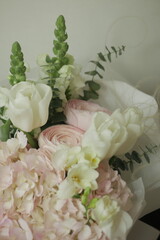 girly, cute, tender, beautiful bouquet. green, white and pink flowers. tulip, ranunculus, hydrangea, eucalyptus branches