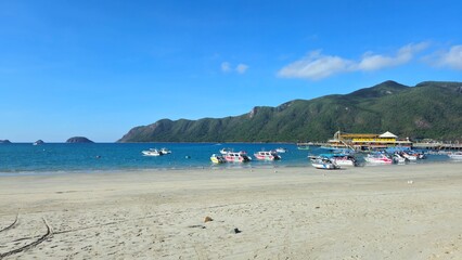 Luxury yacht club and the pier in  at Con Son island, Vietnam in the morning. Yachts in the marina with mountain view.