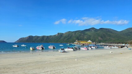 Luxury yacht club and the pier in  at Con Son island, Vietnam in the morning. Yachts in the marina with mountain view.