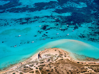 Aerial view of crystal clear beach and boats at Coral Bay, Western Australia, Australia, Ningaloo Reef, fringing reef.
