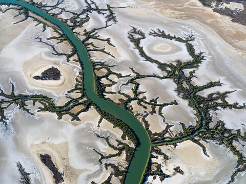 Aerial view of meandering river through desert sand dunes, Accident Inlet, Gulf of Carpentaria, Karumba, Australia.