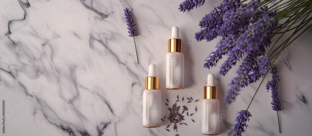Aufkleber Grey background hosts two unbranded cosmetic serum bottles beside a lavender bunch. The view is top-down with ample room for text or graphics - a copy space image.