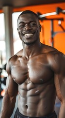 Fototapeta premium Handsome sporty black African American man smiling in the gym, fitness trainer, sport, gym, bodybuilder