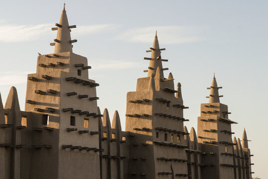 Djenne, Mali - 09 October 2010: View of mud mosque at sunset with towers and spires, Djenne, Mali.