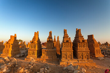 View of Chaukhandi tombs at sunset with ancient stone carvings, Karachi, Pakistan.