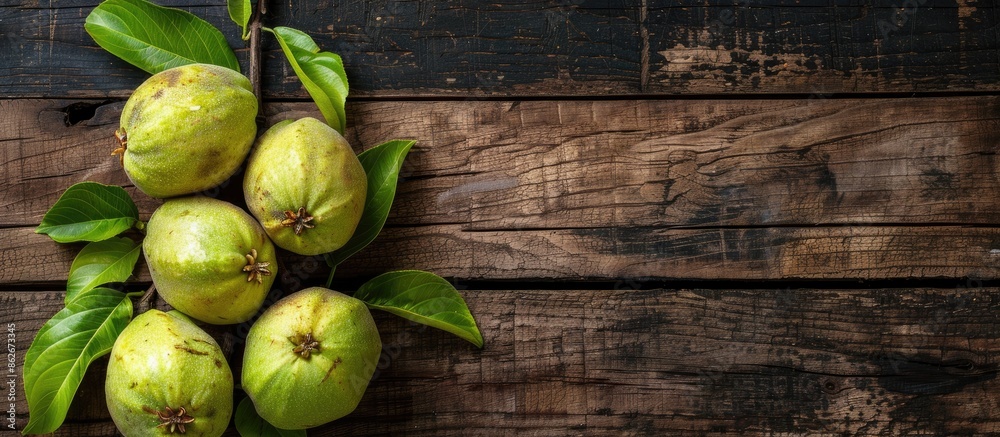 Poster Top view of ripe green guavas displayed on a rustic wooden surface with copy space image.