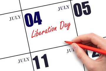 July 4. Hand writing text Liberation Day on calendar date. Save the date.