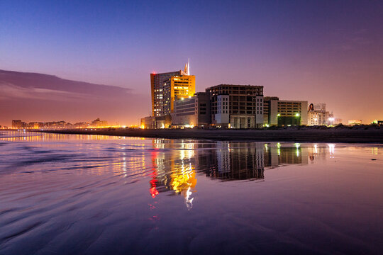 View of Dolmen Mall and city skyline reflection at night, Karachi, Pakistan.