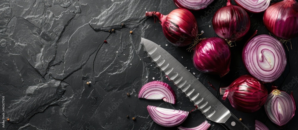 Aufkleber Red and sliced red onions with a knife on a black background in a flat lay style with room for text or other elements in the image. Copy space image. Place for adding text and design