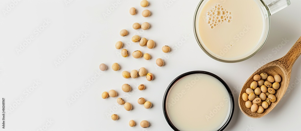 Aufkleber Soy milk in a spoon with soybean, isolated on white background, allowing for text with copy space image.