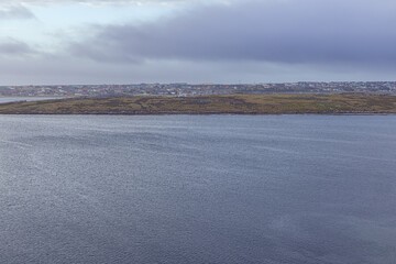Clearing morning sky over Port Stanley, seen from Hamblin Cove in front of the harbor