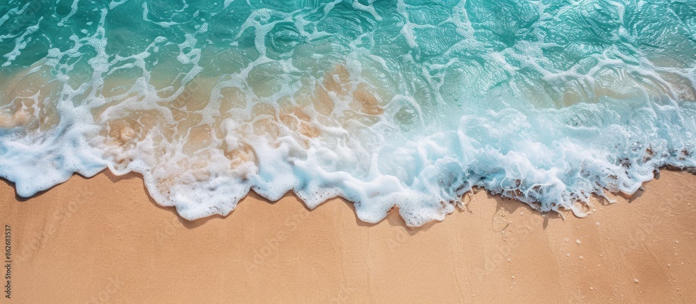 Poster Soothing ocean wave gently washing onto sandy shore, creating a serene summer backdrop with space for a text on a copy space image.