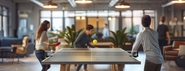 Fototapeta premium Panoramic view of young people playing table tennis in a modern office workplace, captured from a shoulder shot perspective, with a blurred background, digital photorealistic style