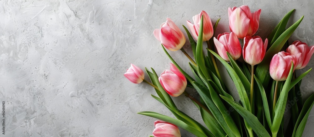 Poster A spring-themed Mother's Day greeting card featuring a bunch of charming pink tulips on a rustic white table, with room for additional elements in the image.