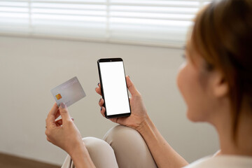 Woman Holding Credit Card Shopping Online with Smartphone at Home - Modern E-commerce and Digital Payment Concept
