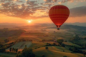 Obraz premium A majestic hot air balloon floating over a picturesque landscape of rolling hills and fields at dawn. 