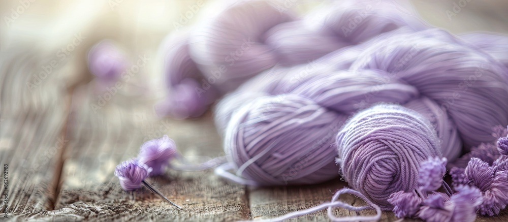 Aufkleber Engaging in knitting as a hobby with a background of a skein of pale lilac wool thread on a wooden table creates a serene and inviting atmosphere for a copy space image.