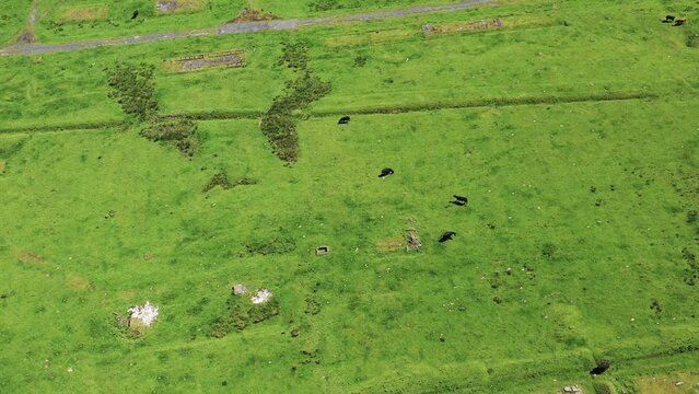 Aerial view of historical ruins and grass fields at Stobs Camp, Hawick, Scotland, United Kingdom.
