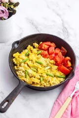 Scrambled tofu with garlic greens and fresh tomatoes