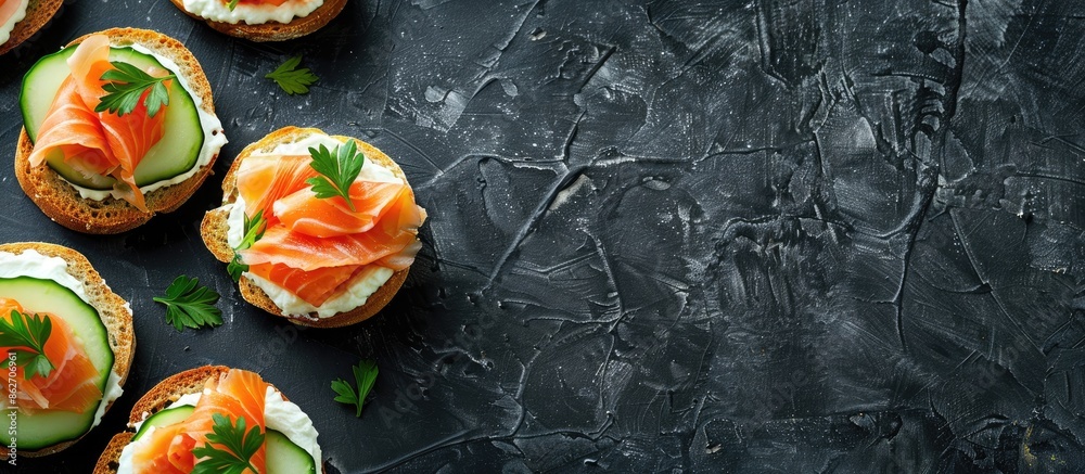 Aufkleber top view of delicious salmon, cream cheese, and cucumber toasts on a black table with ample copy spa