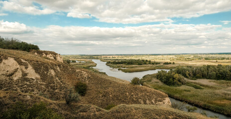 River landscape from a hill to a river valley in summer.