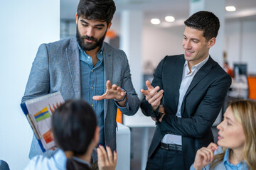 Business people reviewing paperwork in conference room