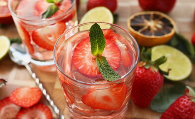 Refreshing cocktails with strawberries, herbs and ice. Making delicious cocktails at home concept