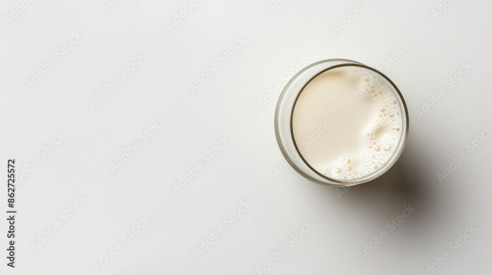 Sticker fresh milk in a glass isolated on a white background seen from above