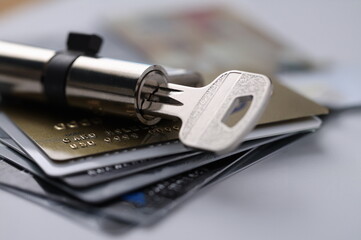 Plastic bank cards are with lock and key. Bank scammers and safety of savings on cards concept