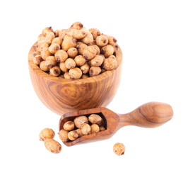 Tiger nuts in wooden bowl, isolated on white background. Pile of chufa nuts, earth almond or chufa sedge. Cyperus esculentus. Top view.